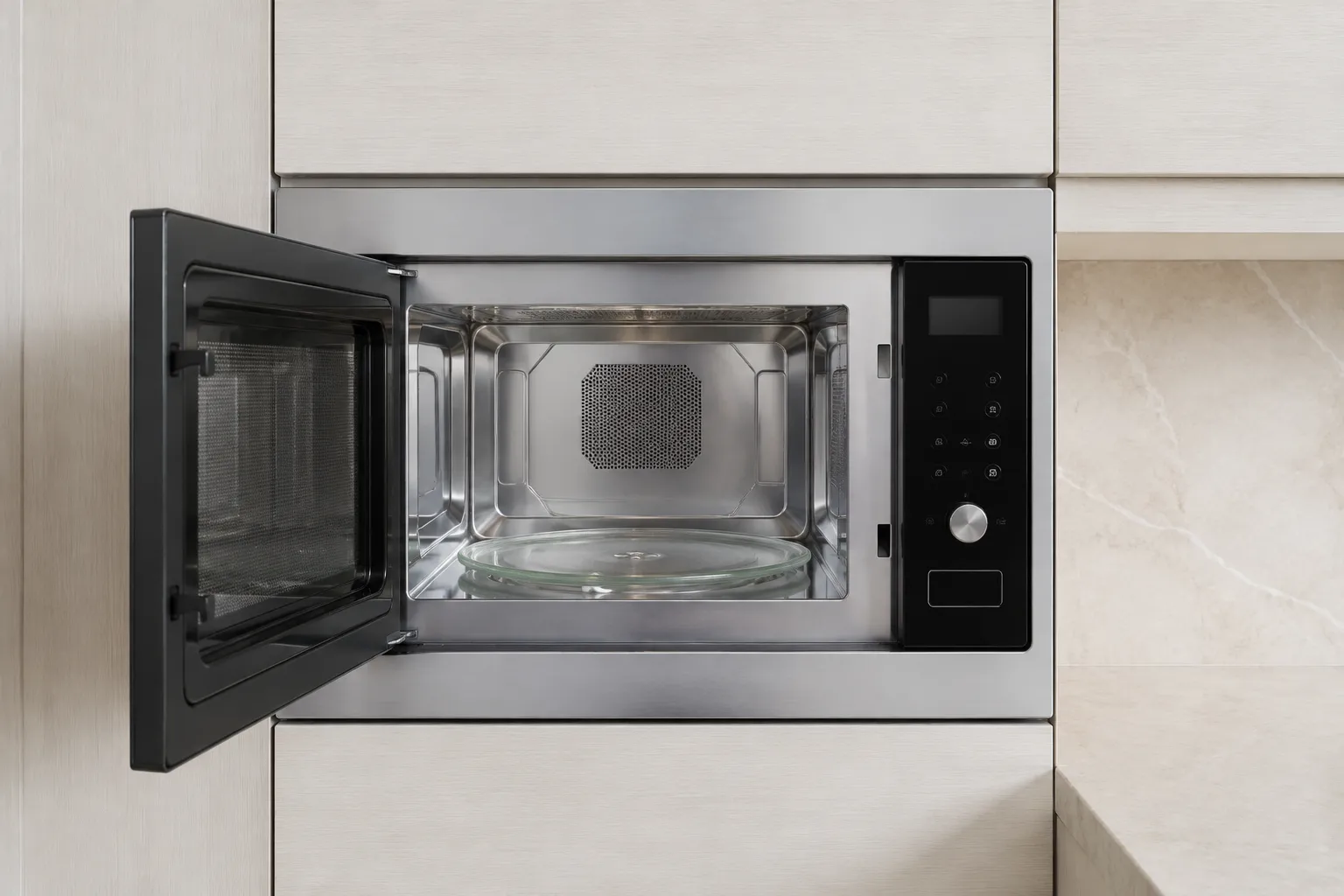 Illustrative built-in microwave with an open door and glass turntable